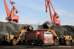 FILE PHOTO: Front loaders transport coal to a truck at a port in Lianyungang, Jiangsu province, China December 8, 2018. REUTERS/Stringer/File Photo ATTENTION EDITORS - THIS IMAGE WAS PROVIDED BY A THIRD PARTY. CHINA OUT.